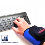 typing with a cordless infrared heating wrist wrap on